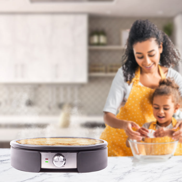 Duronic PM152 crepe maker on counter in family home kitchen cooking crepe with family in background