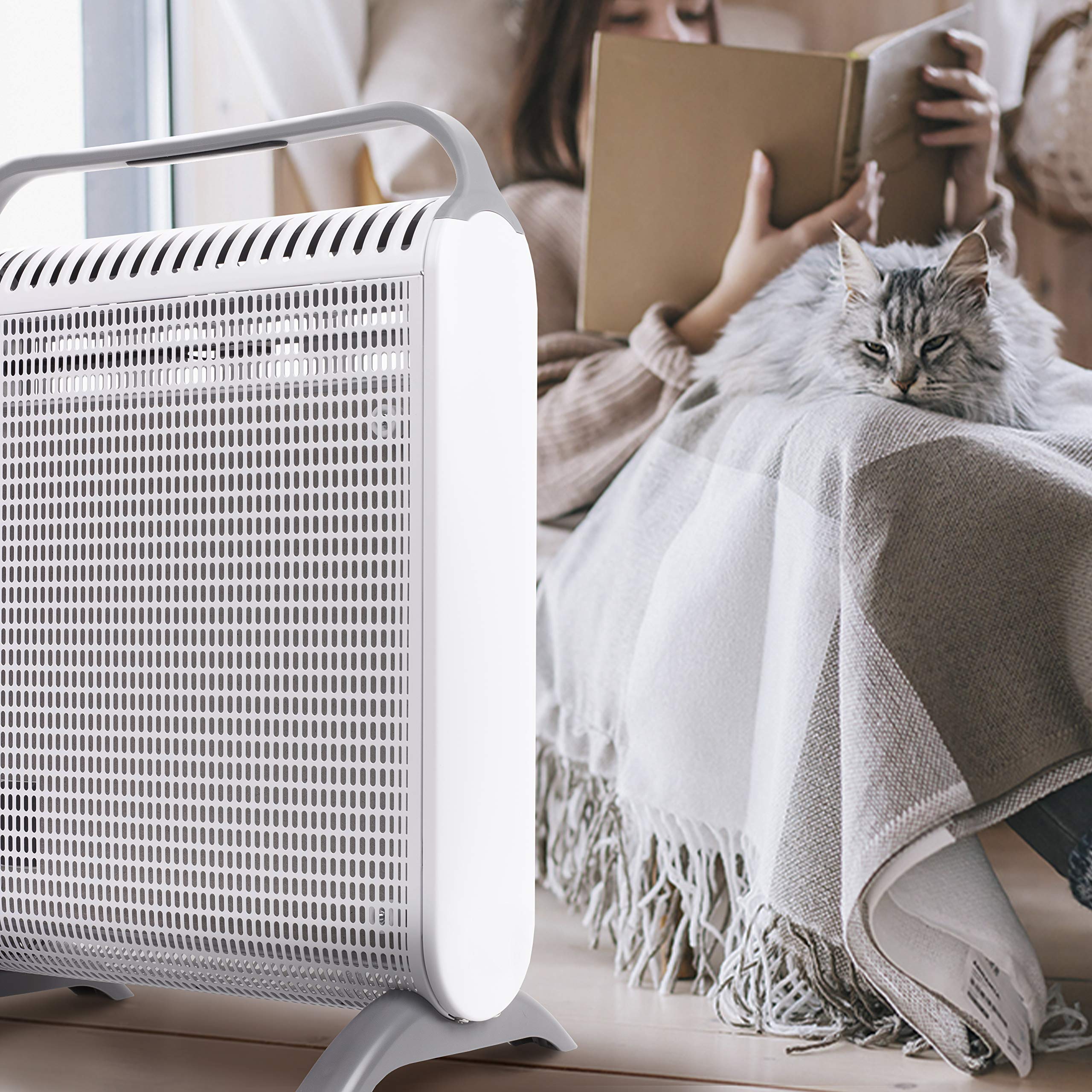 Duronic Electric Heater next to a woman reading with a fluffy cat.