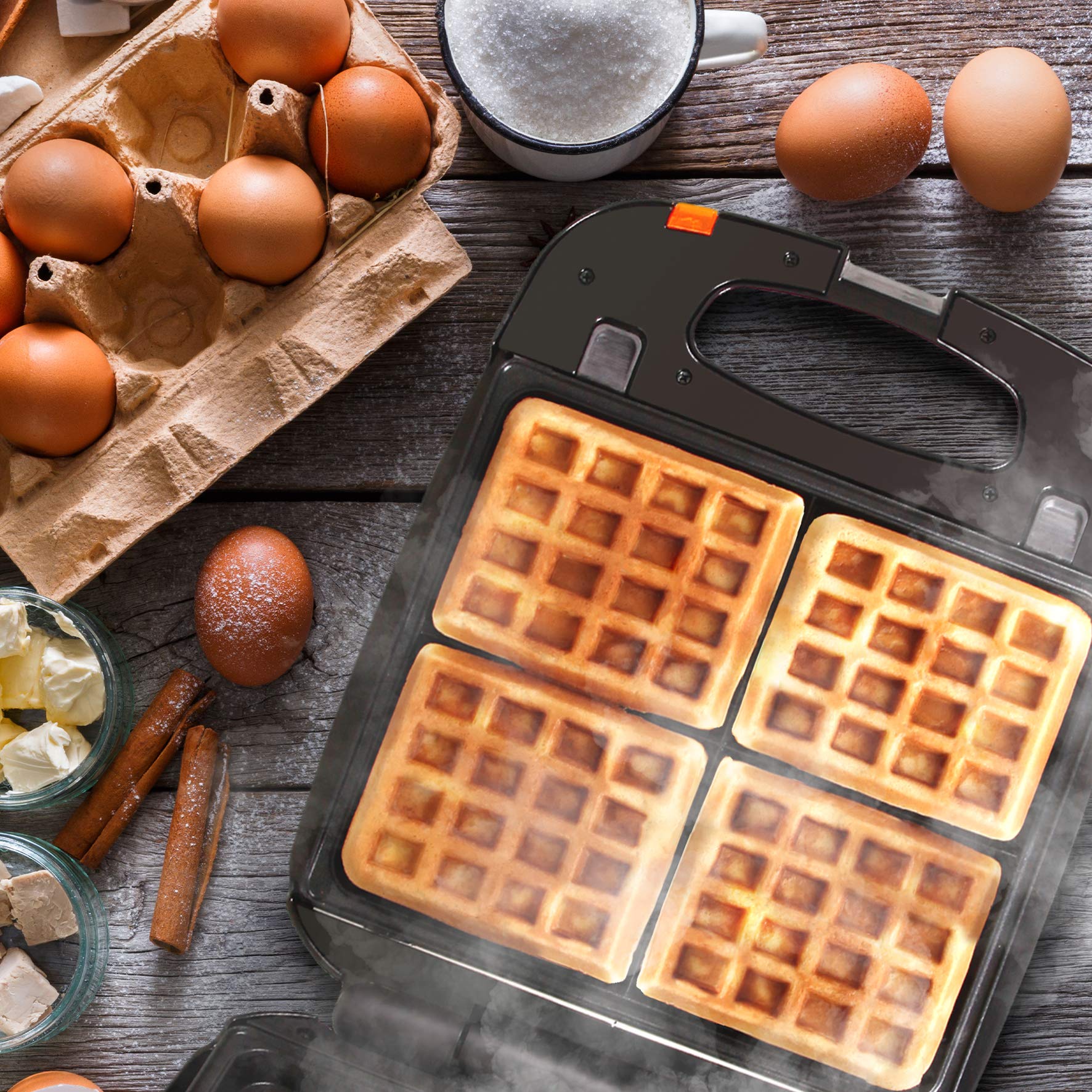 Duronic WM60 electric waffle maker placed aesthetically surrounded by eggs, flour, cinammon, butter to make fluffy waffles