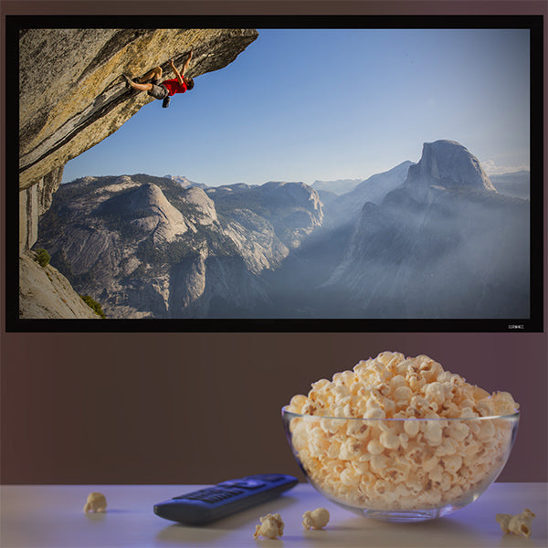 Duronic projector screen placed on wall watching movie with popcorn