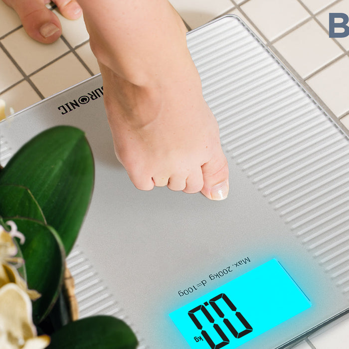 Duronic BS204 digital bathroom scale calibrating weight on a tile floor