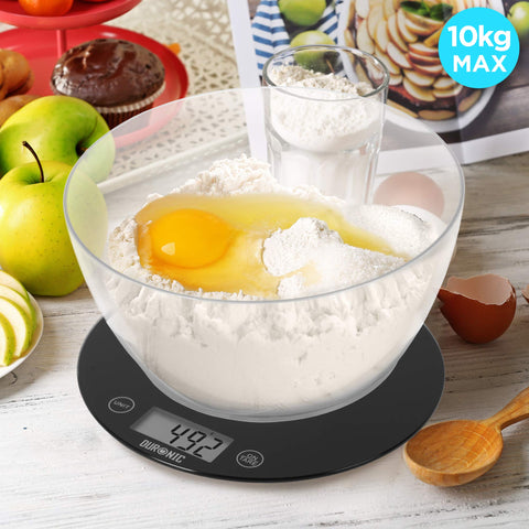 Duronic Digital Kitchen Scale weighing a clear bowl filled with flour and a cracked egg.