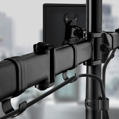 Duronic Dual Monitor Arm Stand Desk Mount featuring integrated cable management clips attached to a vertical desk pole."