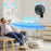 Duronic FN12 BK Wall Mounted Fan with man relaxing on a couch 