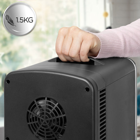 Duronic Mini Fridge Warmer using the integrated top carrying handle feature.