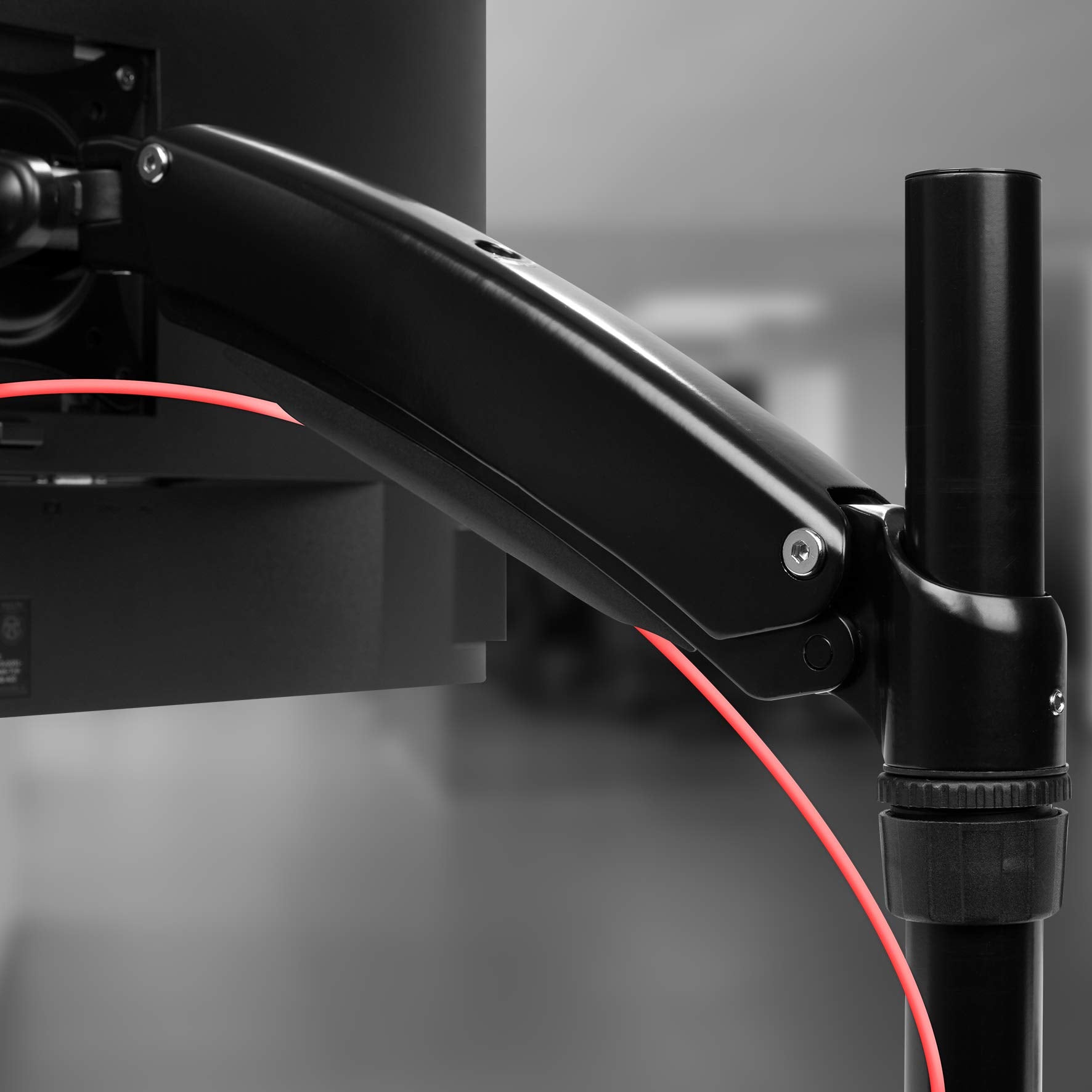 Duronic Monitor Arm Stand mounted on a vertical desk pole, supporting a computer screen.
