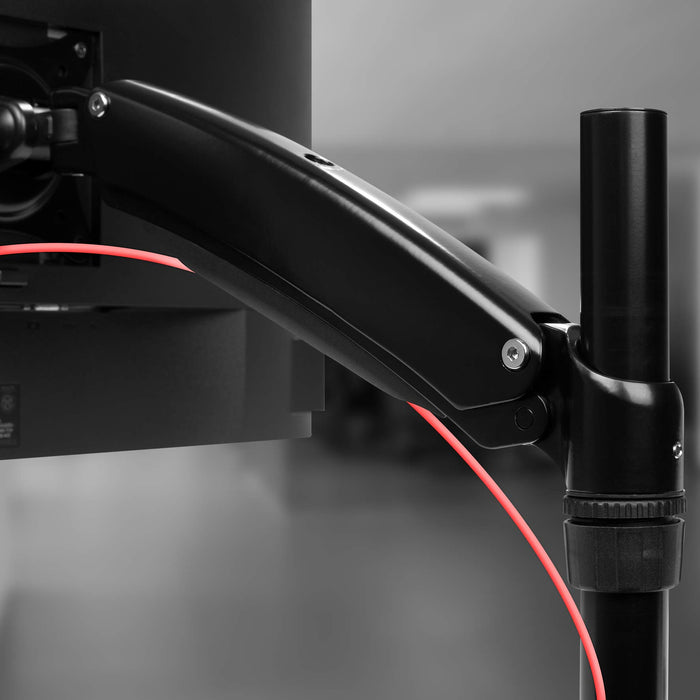 Duronic Monitor Arm Stand mounted on a vertical desk pole, supporting a computer screen.
