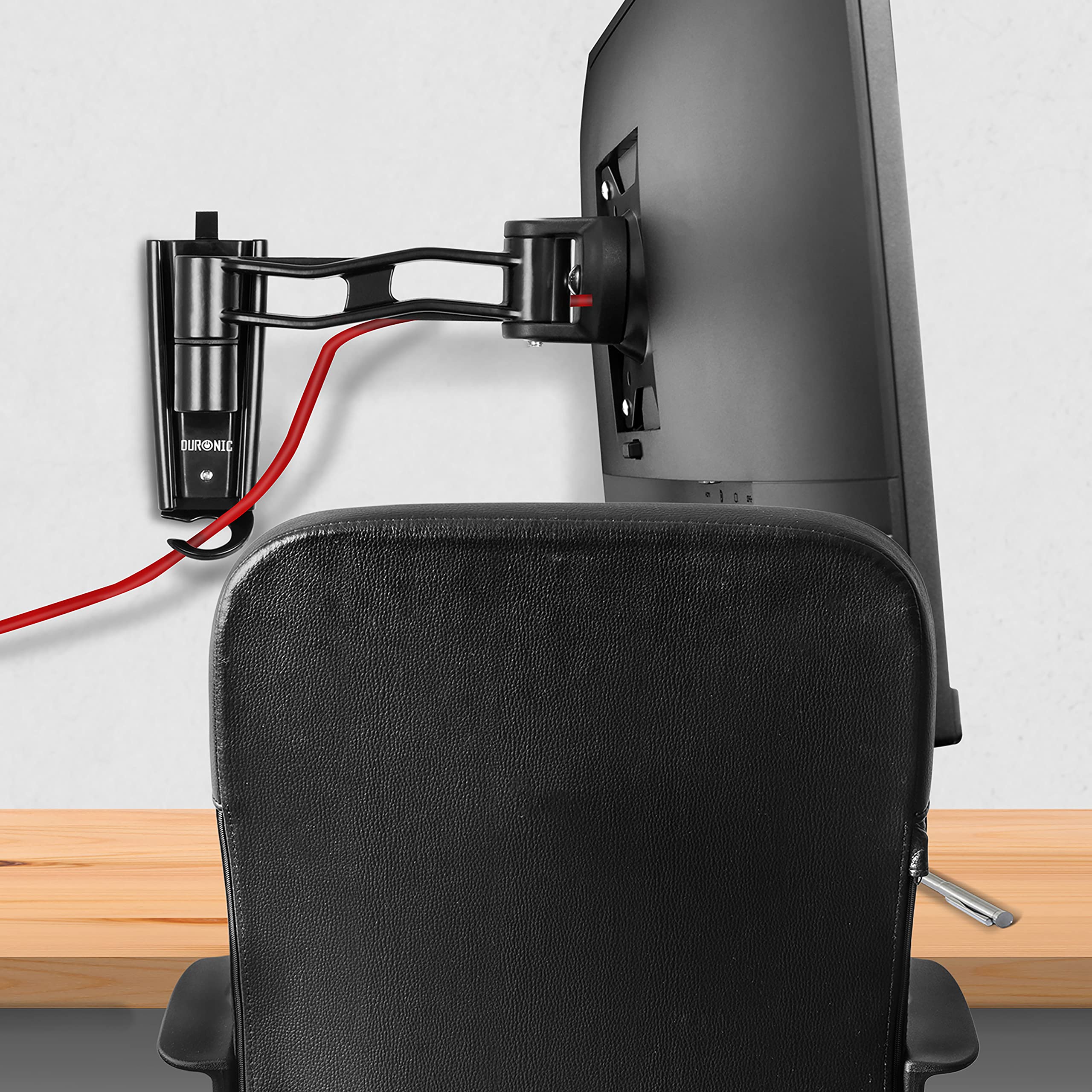 Duronic Monitor Arm Wall Mount holding a computer screen over an office chair and desk.