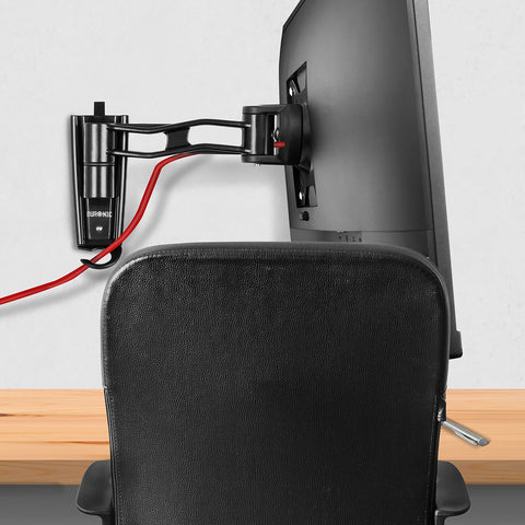Duronic Monitor Arm Wall Mount holding a computer screen over an office chair and desk.