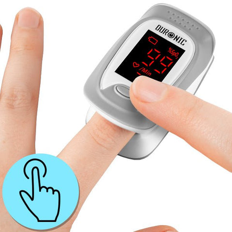 Duronic Oximeter displaying a 99% blood oxygen saturation level on its LED screen while clipped onto a person's index finger.