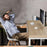 Duronic Single Monitor Arm with a man relaxes at a light wood desk