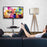 Duronic TV Stand floor mounted on a sleek chrome floor stand next to a wooden tripod lamp.