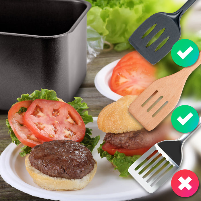 Duronic Twin Drawers AFD2 BK  showing that silicone and wooden spatulas are safe to use with a non-stick air fryer basket, while a metal spatula is marked with a red "X" to indicate it should be avoided.