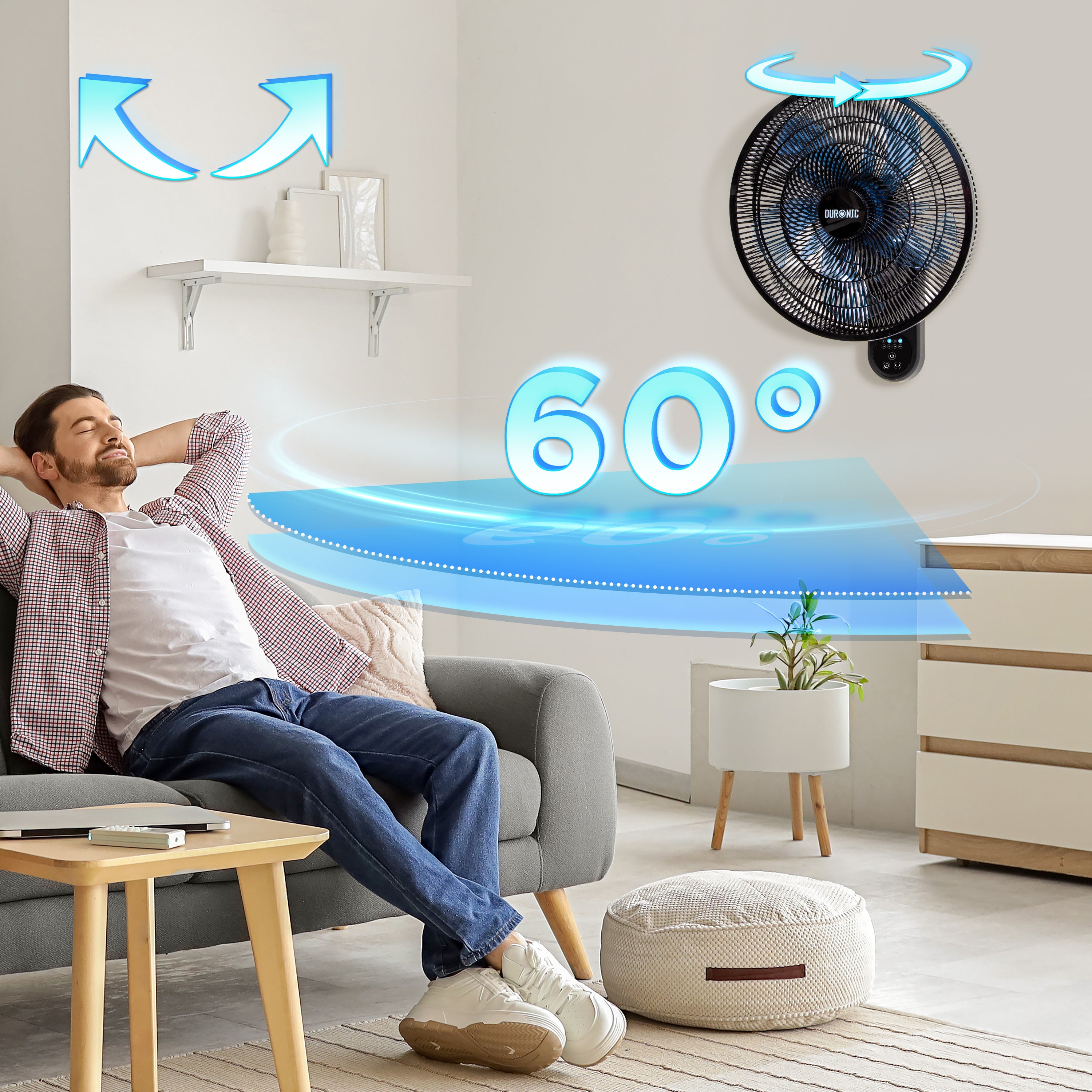 Duronic Wall Mounted Fan with a man relaxing on a living room sofa