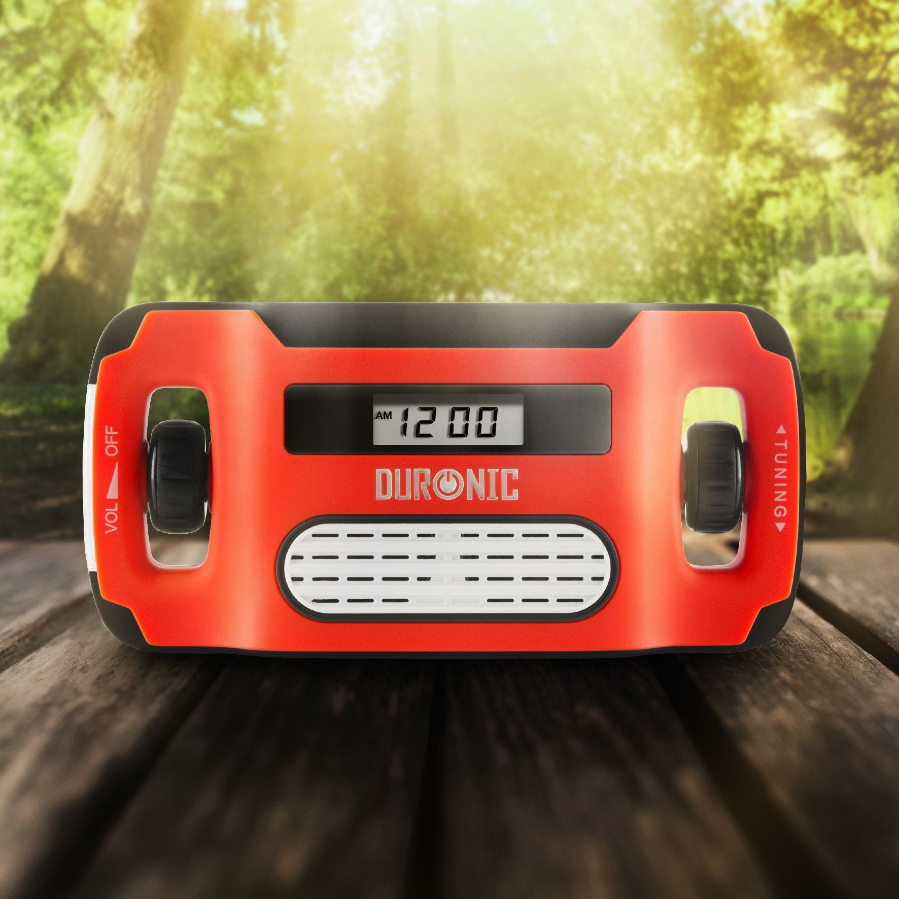 Duronic Wind Up Solar Powered Flashlight Radio Apex with digital clock display on a wooden table outdoors.
