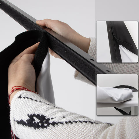 attaching a white projector screen with black borders to a metal frame using a built-in hook-and-loop fastener system.
