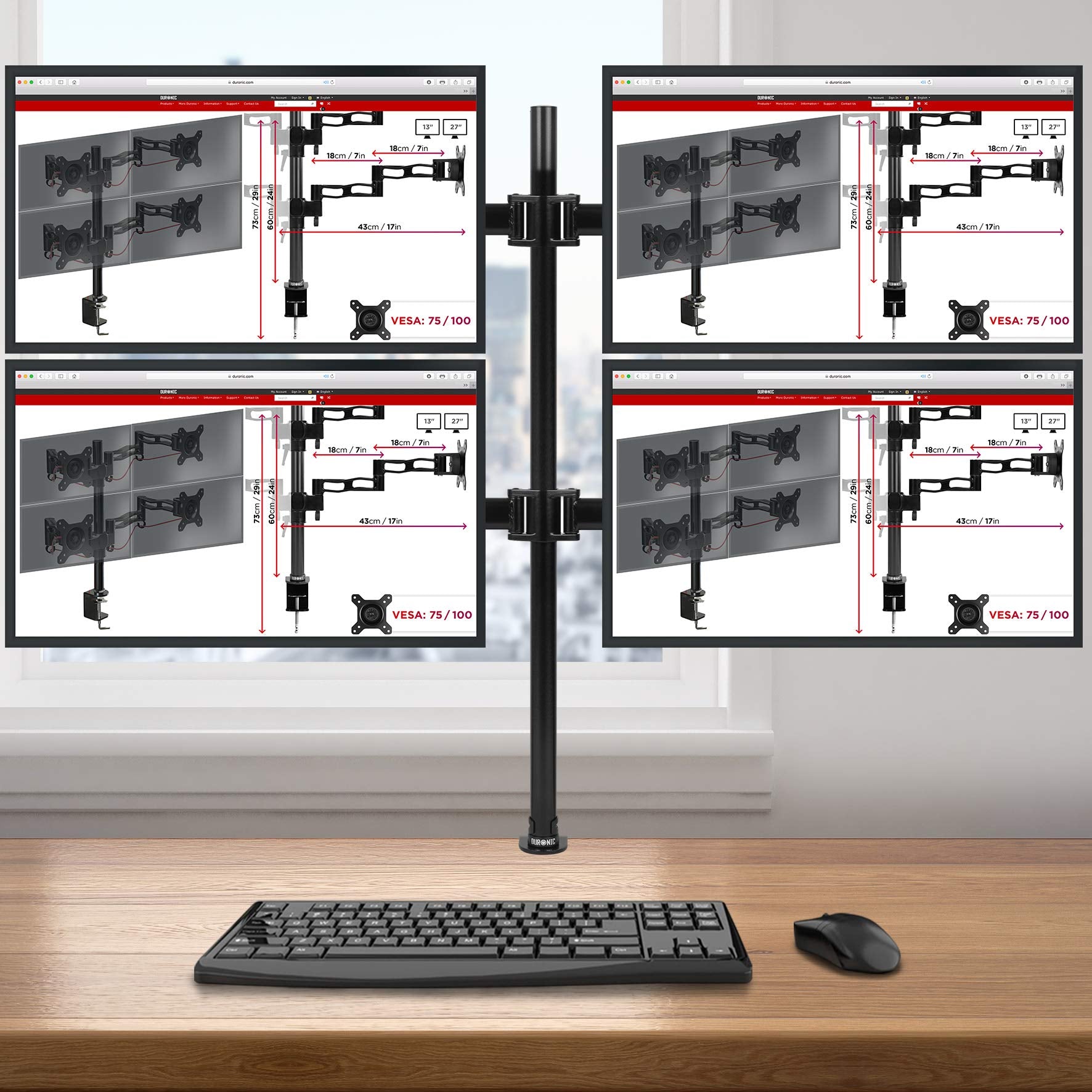 Duronic Computer Quad Monitor Arms holding four screens in a 2x2 layout over a wooden desk.