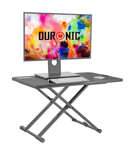Duronic Sit-Stand Desk with a monitor, keyboard, and mouse on a black desktop.