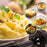 
A close-up of creamy mashed potatoes with parsley and crispy garlic, surrounded by inset images of shepherd's pie, sweet potato mash, potato croquettes, and stuffed skins, showcasing various dishes made with a potato masher tool.