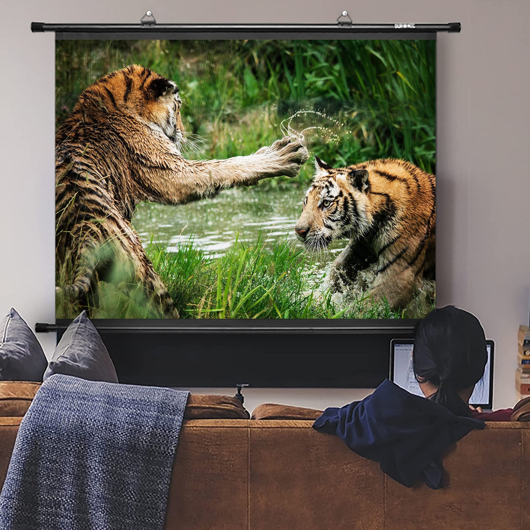 Duronic Bar Projector Screen with Person sitting on a couch watching an image of two tigers playing