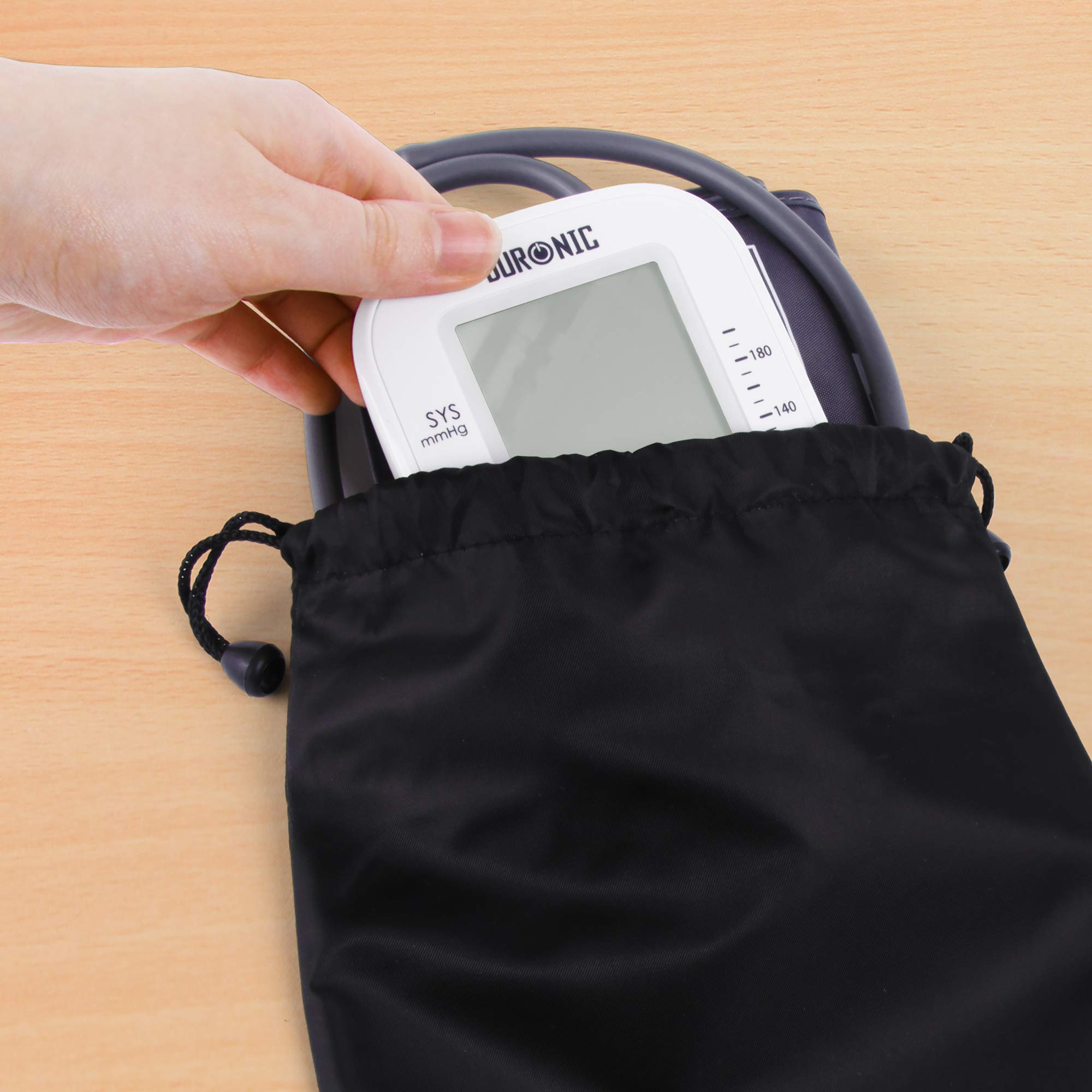 Duronic Blood Pressure Monitor into a black drawstring storage pouch.