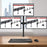Duronic Computer Monitor Arms holding three screens above a desk with a keyboard and mouse.