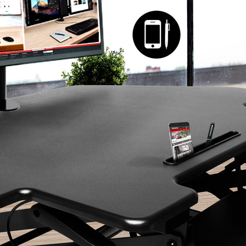 Duronic DM05D5 Corner Sit-Stand  Desk featuring a built-in accessory slot that holds a smartphone and pen for an organized workspace..