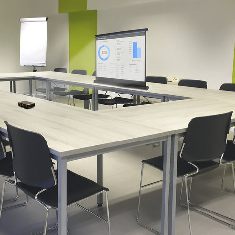 Duronic DPS40/43 portable projector screen placed on office business desk for engaging interactions