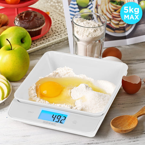 Duronic Digital Kitchen Scales weighing flour and a cracked egg with a blue backlit display.
