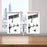 Duronic Dual Monitor Stand with adjustable arms and swivel joints clamped to a wooden office desk.