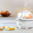 Duronic EB27 WE electric egg cooker placed on aesthetic kitchen countertop cooking eggs alongside egg dishes