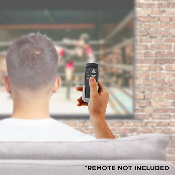 Duronic Electric 60” Projector Screen man sits on a couch holding a handheld remote control toward a large projection screen displaying a boxing match in a home theater setting