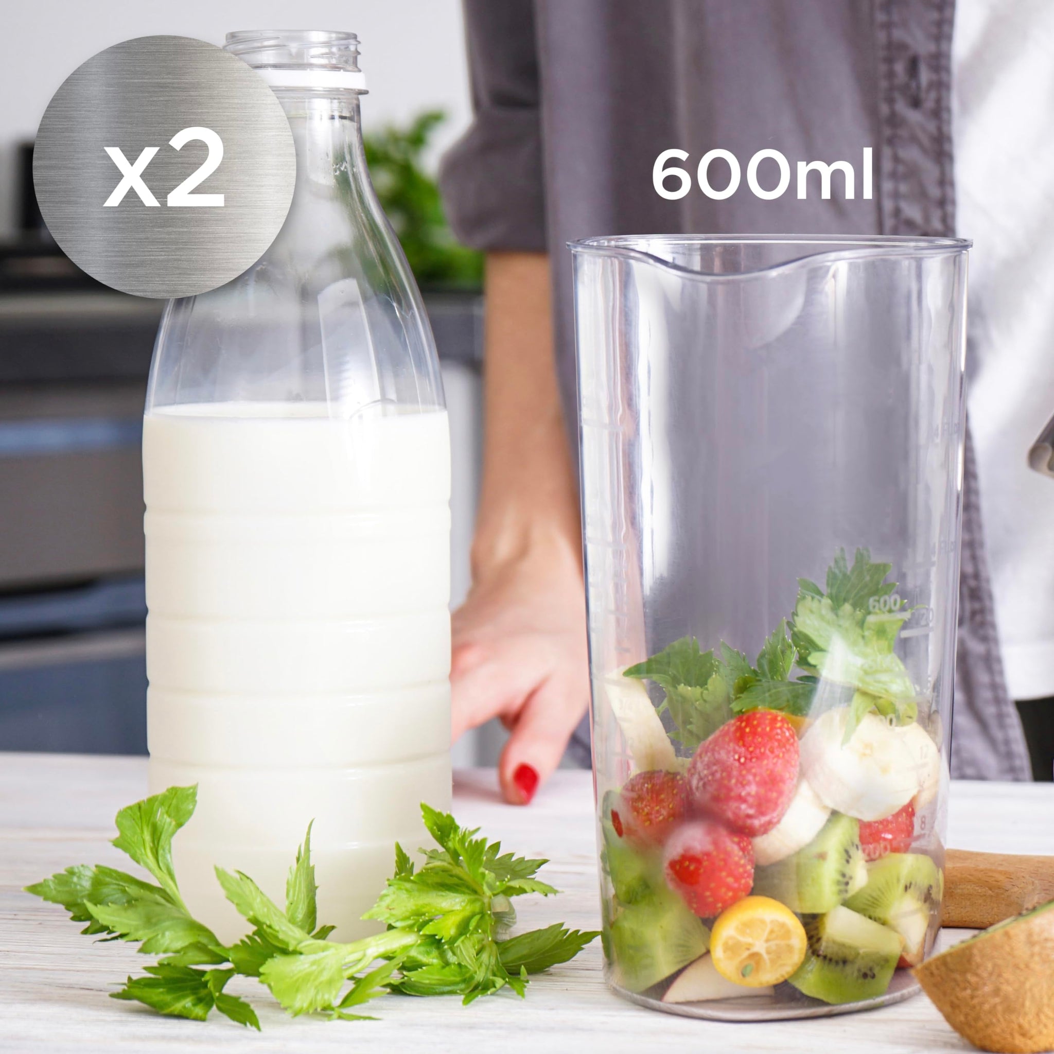 Duronic Electric Hand Blender with fresh fruit and greens stands next to a bottle of milk, indicating a 2-pack set for smoothie preparation.