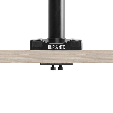 Duronic Grommet 3 with a black pole clamped securely to a light wood tabletop.