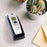 Duronic IRT1000 dual mode thermometer placed on stand provided for easy access placed on table