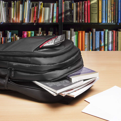 Duronic Laptop Backpack stuffed with books and a calculator on a table before a bookshelf.