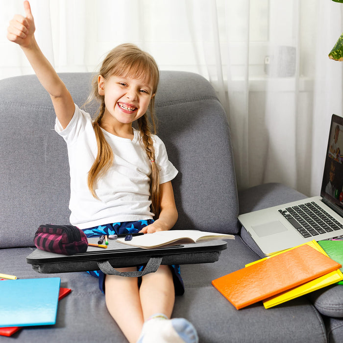 Duronic Laptop Tray with smiling young girl using a portable lap desk on a couch with school supplies nearby