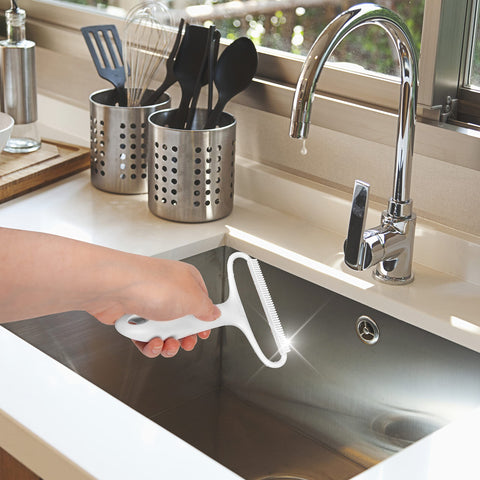 Duronic Lint Shaver held over a kitchen sink for easy cleaning and maintenance.