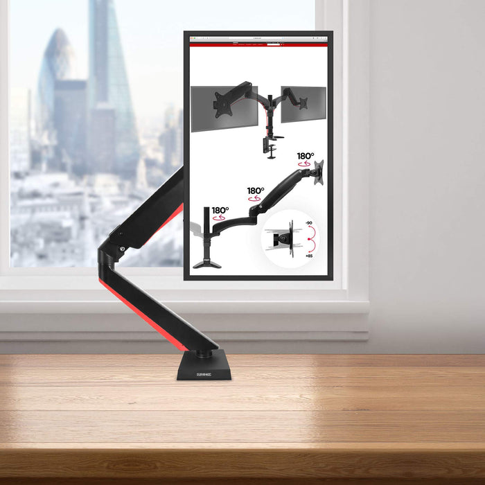 Duronic Monitor Arm Stand clamped to a desk in a modern office.
