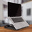 Duronic Monitor Laptop Stand set on a wooden desk with blurred background..