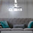Duronic Projector Mount Ceiling-mounted projector casting light in a living room above a grey sofa with blue pillows.