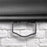 Duronic Projector Screen pull down projector screen handle against white brick wall.