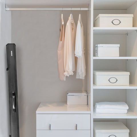Duronic Projector Screen showing hanging clothes, organized storage boxes, and a tall black case