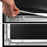 Duronic Projector Screen with Hand installing a projector screen by hooking its tension rods onto a metal frame.