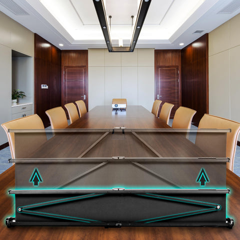 Duronic Projector Screen with a black casing and hydraulic scissor backing is shown expanding upward on a conference room table.