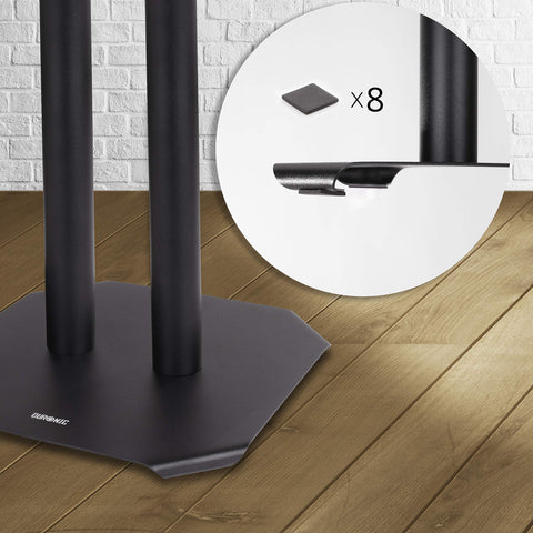 Duronic SPS1022-40 Speaker Stand featuring a circular inset showing eight adhesive foam pads being applied to the underside for floor protection.