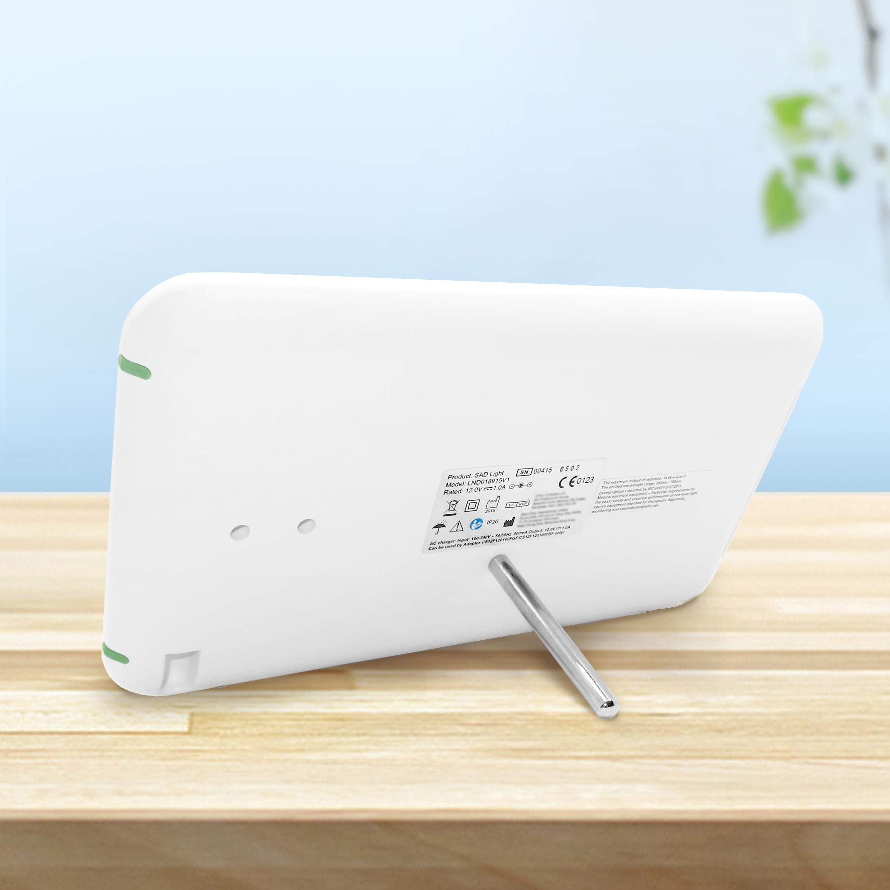 Duronic Sad Light Therapy Lamp Box with silver kickstand on wooden surface.
