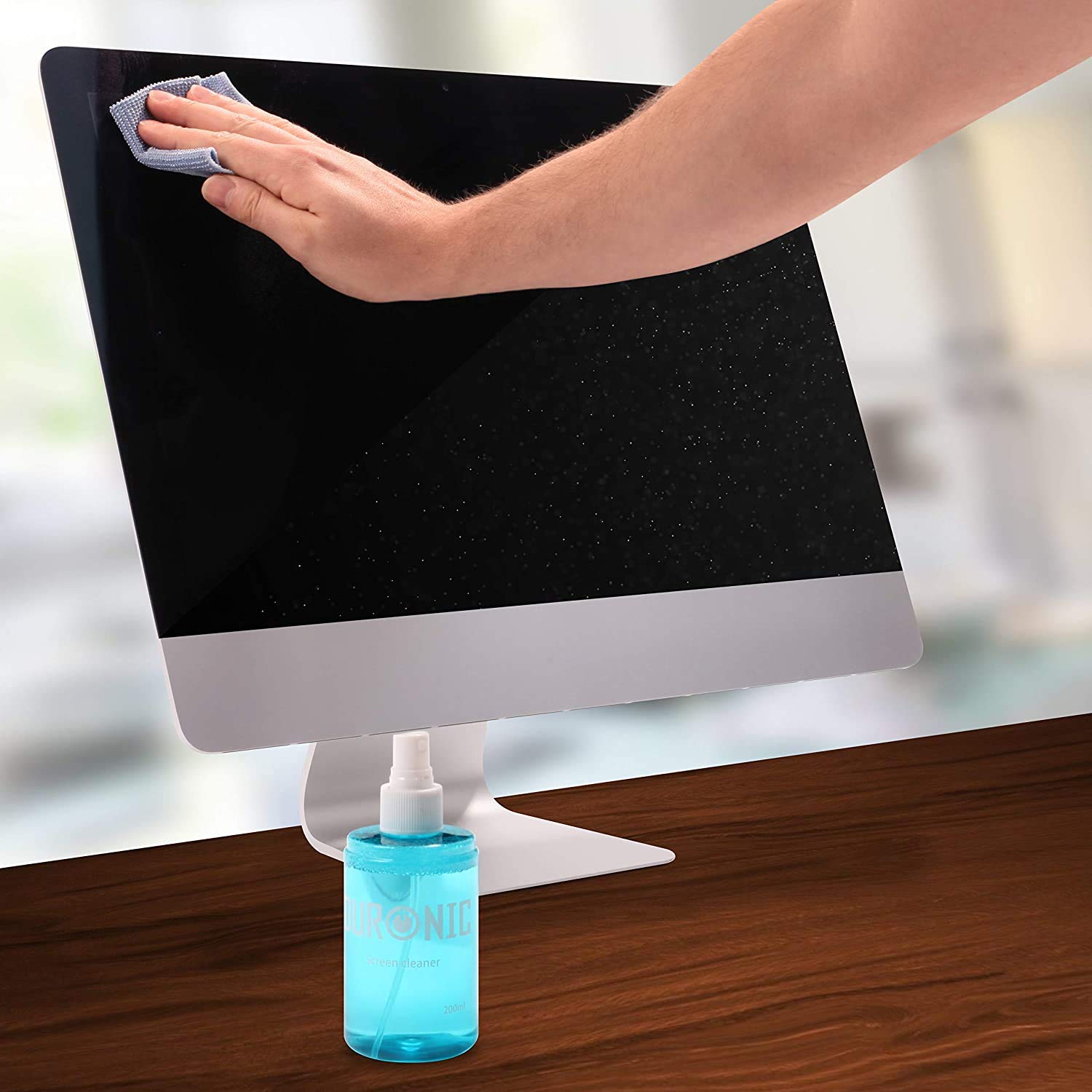 Duronic Screen Cleaner with Hand wiping a computer screen with a microfiber cloth next to a blue spray bottle.