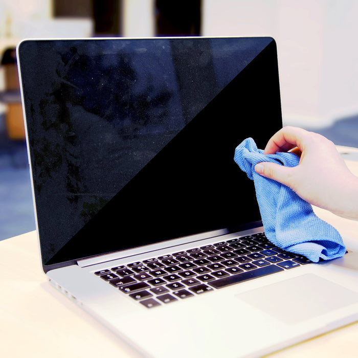 Duronic Screen Cleaner with a Hand wiping a dirty laptop screen with a blue microfiber cloth on a desk.
