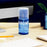 Duronic Screen Cleaner with microfiber cloth on a wooden desk.